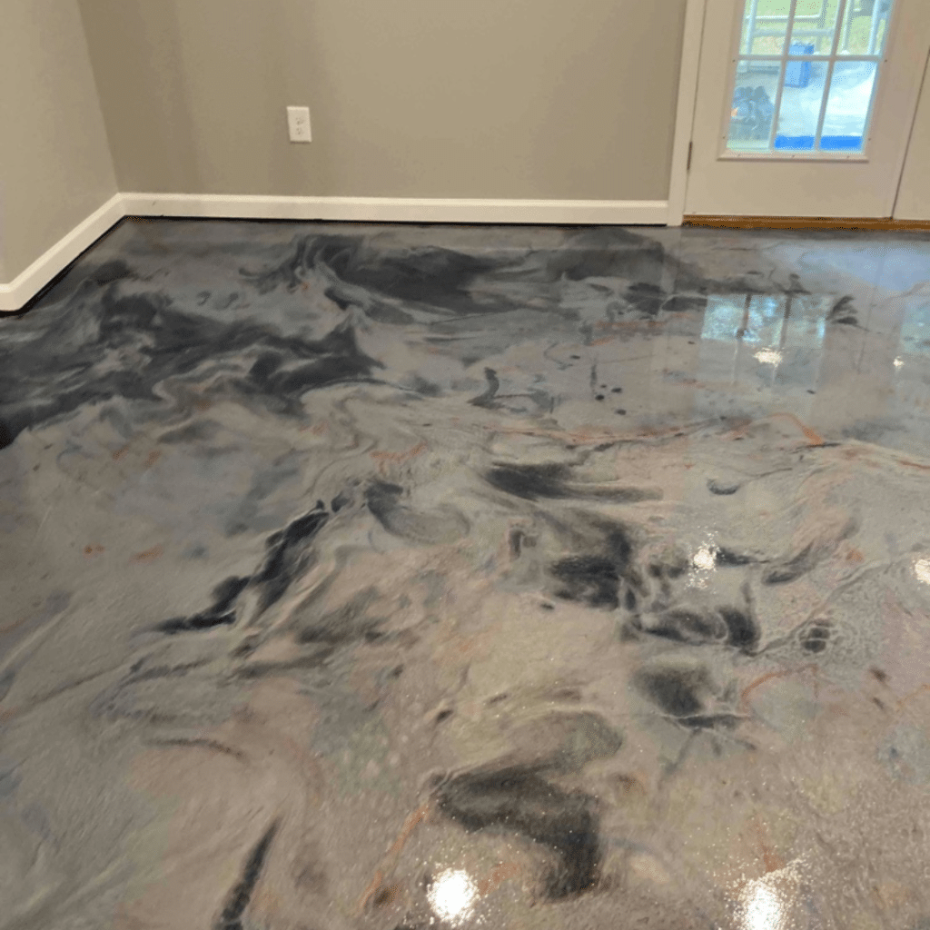 Our Work - Photo of a metallic marble epoxy floor indoors, featuring a high-gloss finish with a swirling, marbled effect that provides a luxurious and unique flooring solution for any home or commercial space.