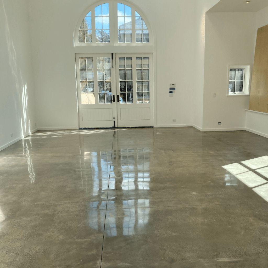 Our Work - Photo of a polished concrete residential floor featuring a glossy, smooth surface with a sleek and modern appearance. This durable and low-maintenance flooring option provides a practical and stylish option for any home.