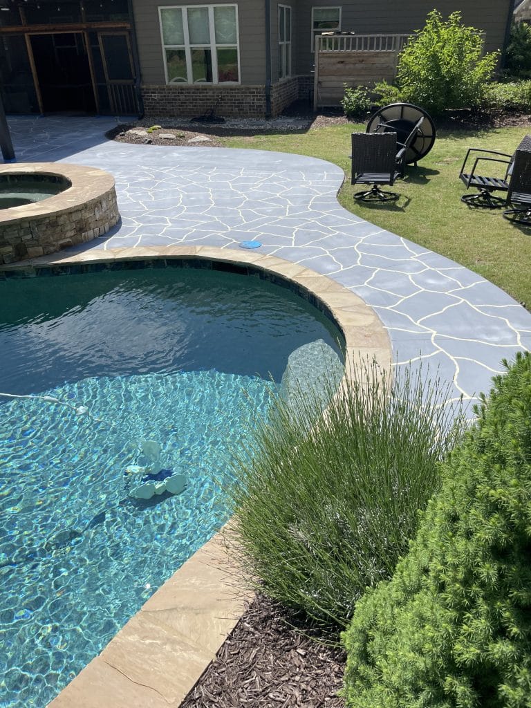 Our Work - Flagstone pattern going down on a pool deck overlay